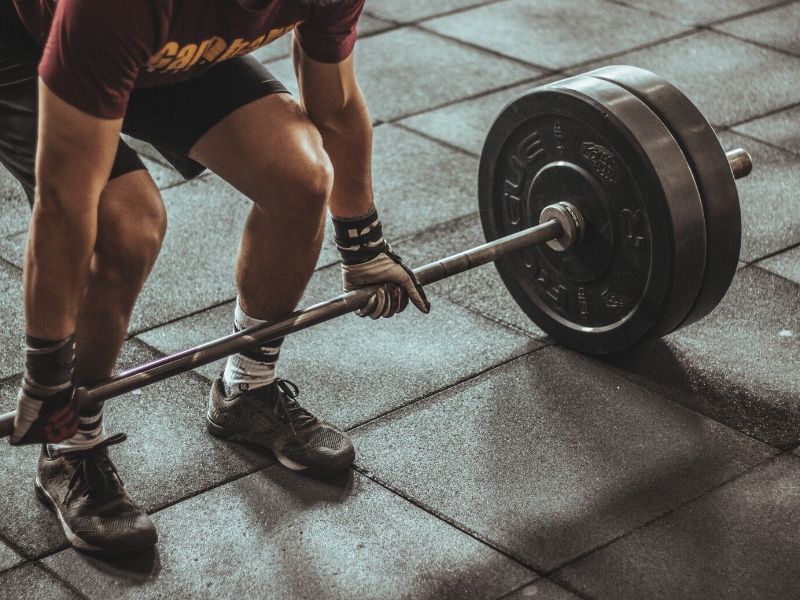 a man lifting a barbell