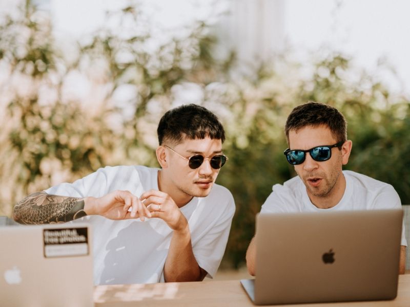 two entrepreneurs getting to work on laptops