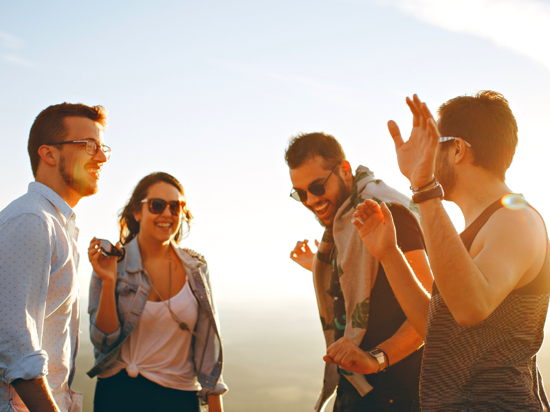 4 young millennials celebrate at sunset